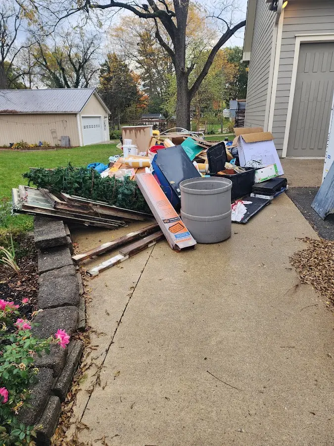 Dumpster being loaded with debris for 30 Yard Dumpster Rental in Cherryvale